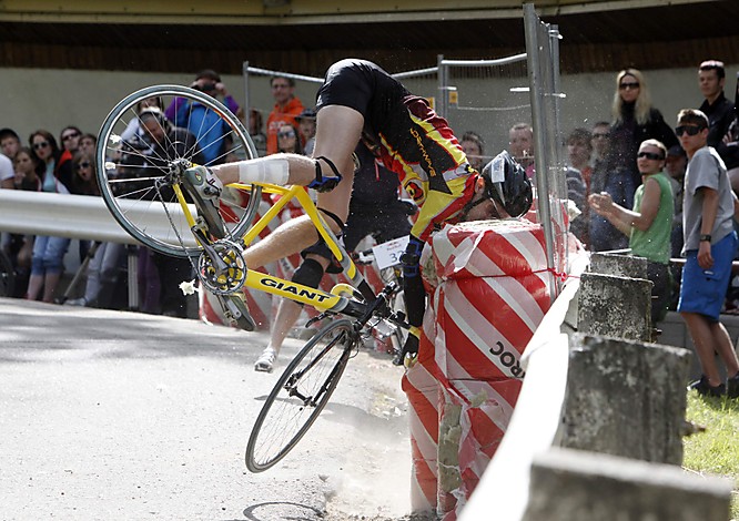 A rider crashes into a security wall during the Red Bull Road Rage bike downhill race in Sigulda